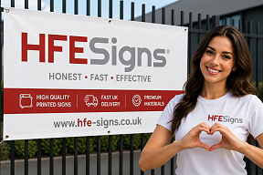Woman making heart shape with hands beside HFE Signs printed advertising banner with fast UK delivery branding