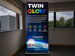 TwinGlow light-up roller banner showcasing enhanced visibility compared to traditional non-lit pull-up banners