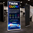 TwinGlow illuminated double-sided roller banner display at exhibition stand, brighter than standard pull-up banners